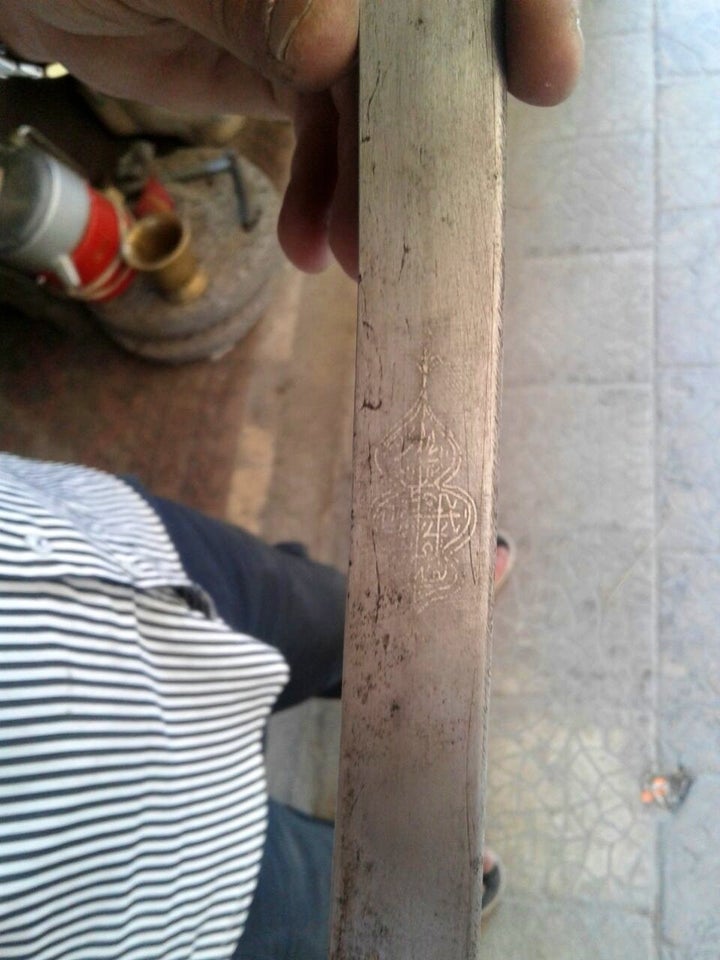 Abu Abdo holds a sword with Islamic engravings. Eastern Ghouta, June, 2016.