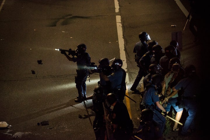 Two protesters are arrested on a highway embankment on Saturday in St. Paul, Minnesota.