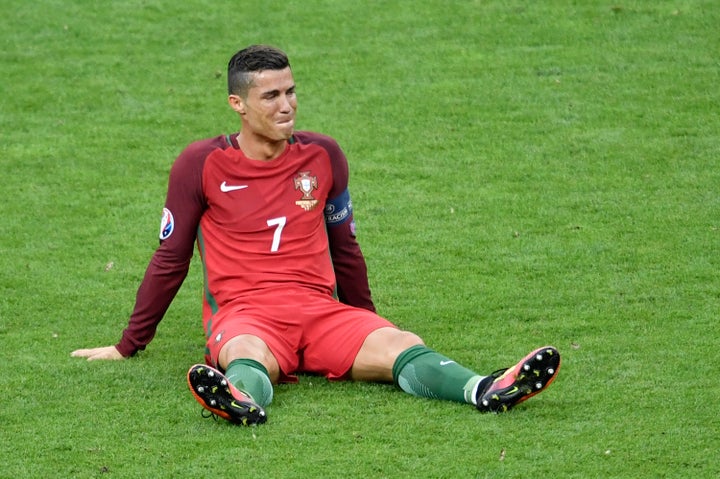 Portugal's forward Cristiano Ronaldo reacts after an injury following a clash with France's forward Dimitri Payet. 