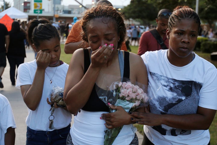 Keaka Wallace, (C) who says she was a patrol partner of slain DART officer Brent Thompson weeps as she leaves a makeshift memorial at Dallas Police Headquarters following the multiple police shooting in Dallas, Texas, U.S., July 8, 2016.