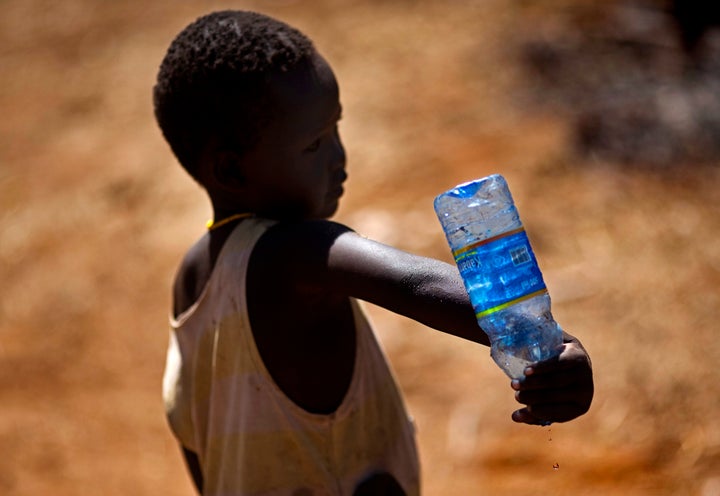 NARIMETO, KENYA - FEBRUARY 03: Water shortage in North Kenya, an infant is spilling the last water drops out of a bottle. (Photo by Thomas Trutschel/Photothek via Getty Images)