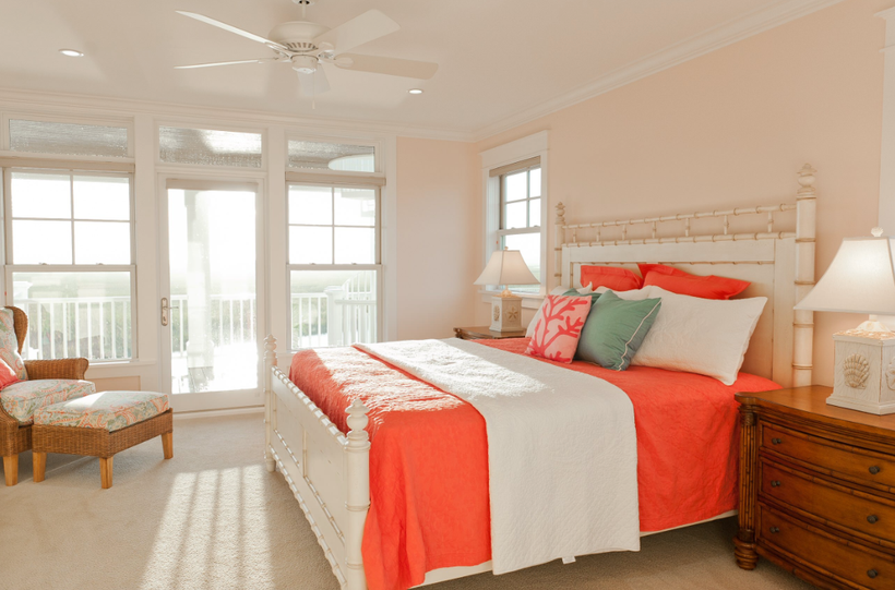 Bright bedding livens up soft peach walls. 