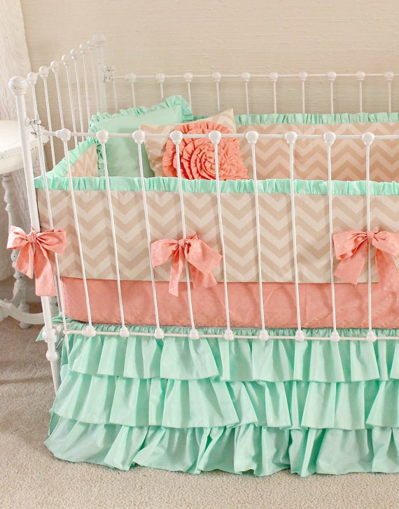 Mint green and coral create a soothing nursery.