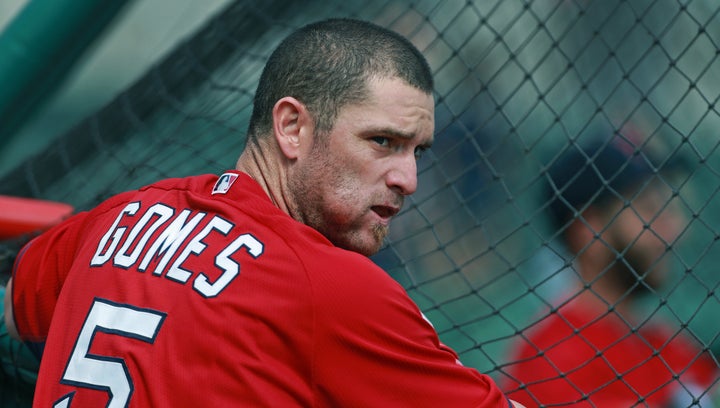 Former Red Sox player Jonny Gomes sucks on a wad of chewing tobacco in February 2014. 