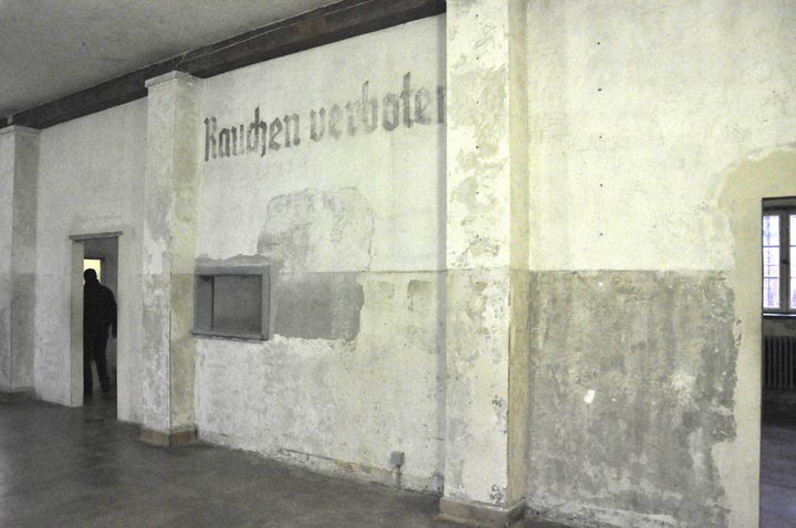 "On the walls, the pain had finally peeled off, years after Dachau was liberated to reveal an imprint: “Rauchen verbote