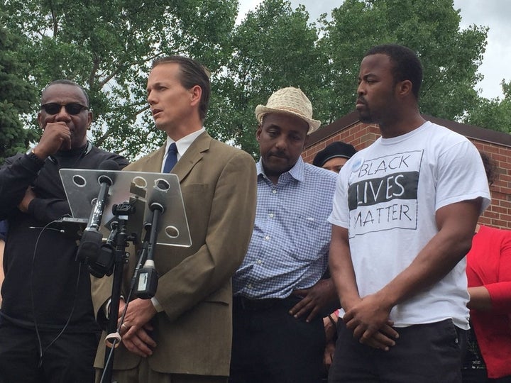 Falcon Heights Mayor Peter Lindstrom (at microphone) and Black Lives Matter organizer Rashad Turner (far right) speak outside of the Falcon Heights city hall on July 8.