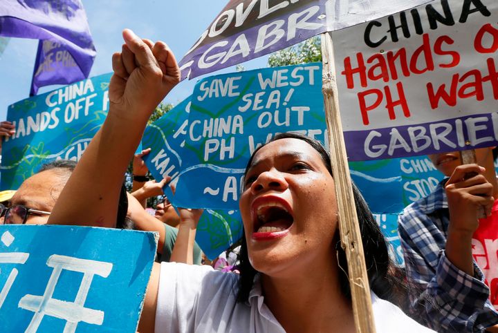 Filipinos protest hours before the ruling Tuesday China's expansion of its presence in the South China sea, which is keeping Philippine fishing vessels away.