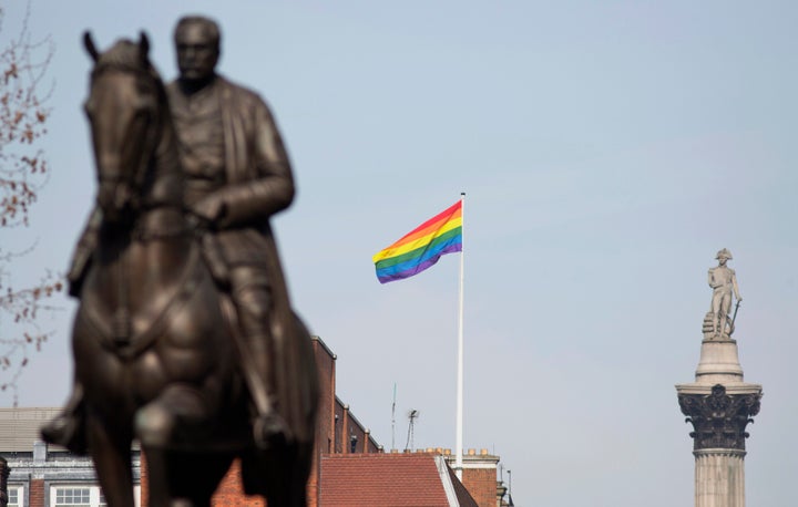 The rainbow flag is seen between statues of Field Marshal Earl Haig and Admiral Lord Nelson, marking the first day Britain allowed same sex marriages in 2014