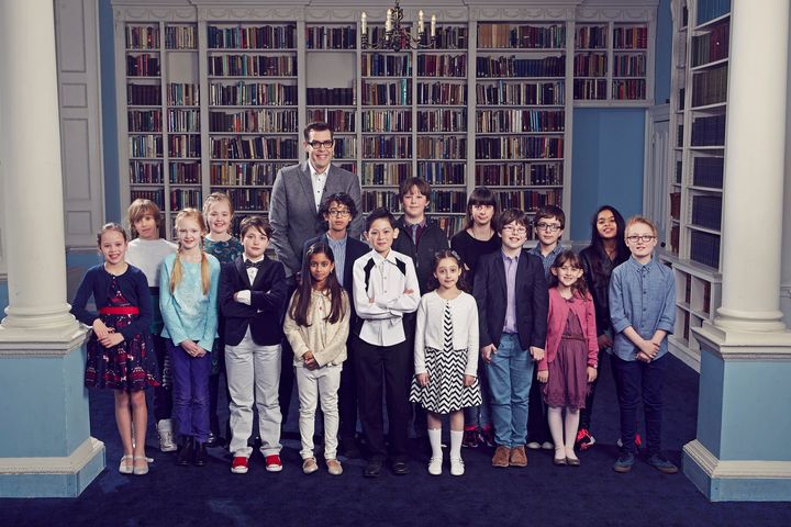 The 16 contestants with host Richard Osman.
