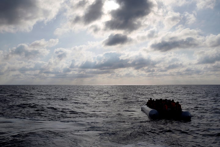 A humanitarian organization rescued hundreds of migrants from a wooden boat in the Mediterranean Sea on Tuesday. Pictured here, migrants in a dinghy await rescue in June 2016.