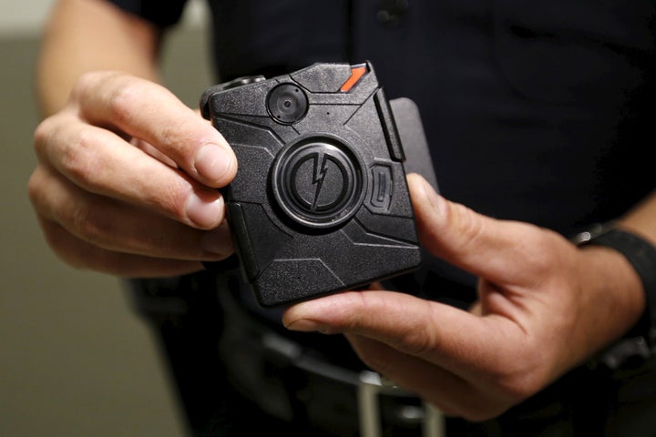 LAPD information technology bureau officer Jim Stover demonstrates the use of the body camera during a media event in Los Ang