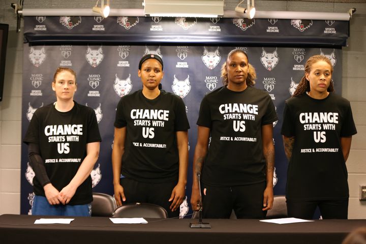 Lindsay Whalen #13, Maya Moore #23, Rebekkah Brunson #32, and Seimone Augustus #33 of the Minnesota Lynx attend a press conference to speak about recent shootings and racial profiling.
