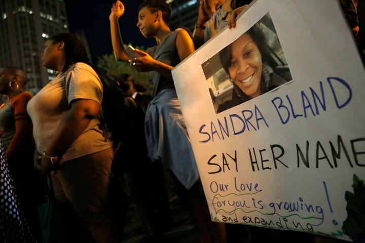 A demonstrator holds a Sandra Bland sign during a vigil in July 2015.
