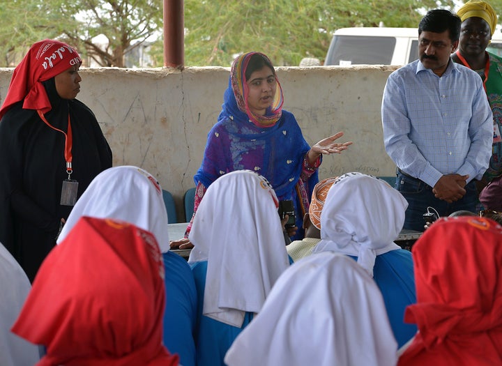 Pakistani activist for female education and the youngest-ever Nobel Prize laureate Malala Yousafzai addresses young refugees at Kenya's sprawling Dadaab refugee complex during a visit organised by the UN High Commissioner for Refugees, in Garissa on July 12, 2016. / AFP / TONY KARUMBA (Photo credit should read TONY KARUMBA/AFP/Getty Images)