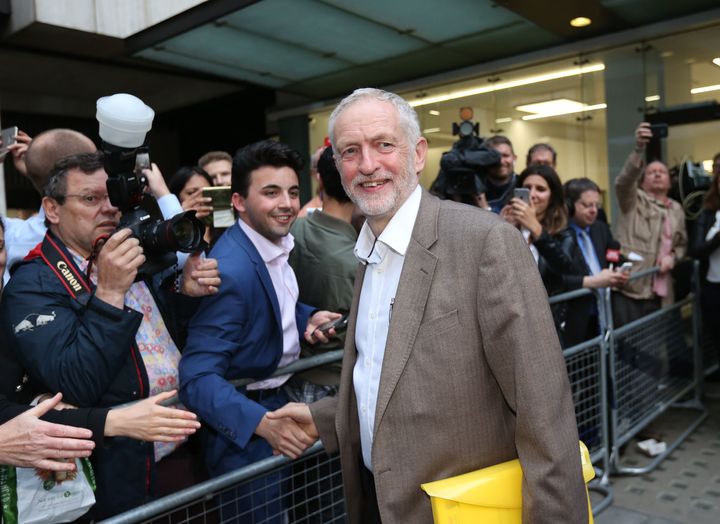 <strong>The real Jeremy Corbyn leaves Labour HQ after it was ruled that his name would automatically be included on the leadership ballot</strong>