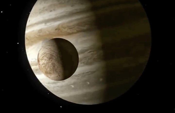 An illustration showing Europa crossing in front of Jupiter.