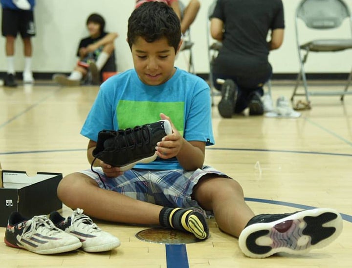 Diego is thrilled to receive his first pair of basketball shoes from Hav A Sole