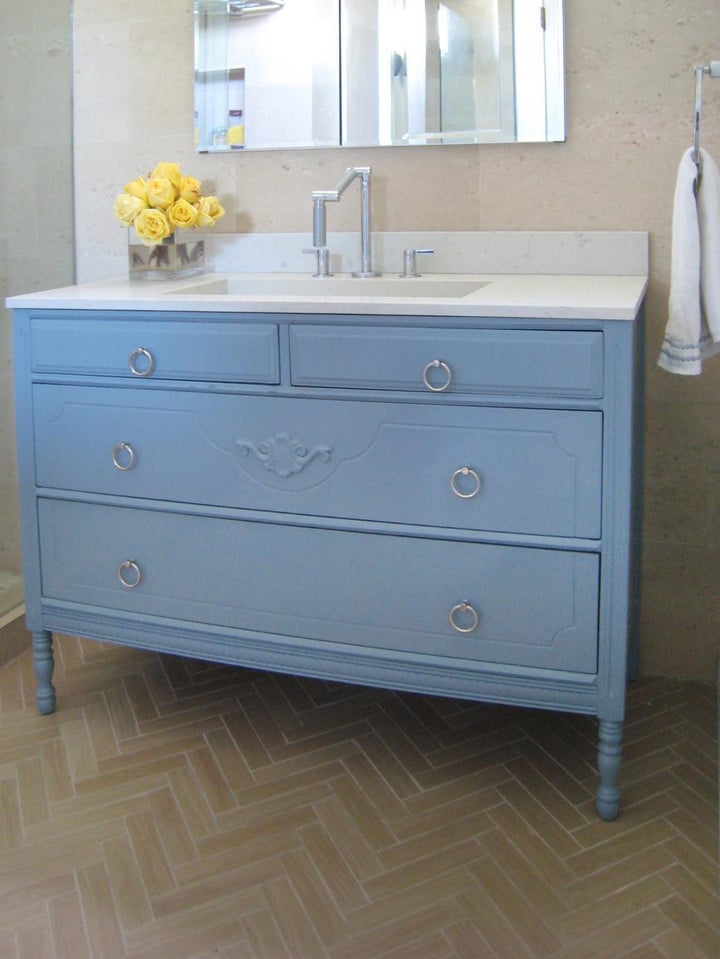 A vintage dresser is used as a new vanity.