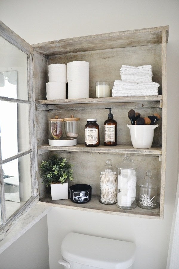 A window made into a cabinet adds space in the bathroom.