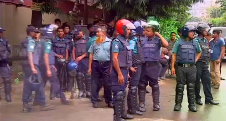Police gather after gunmen attacked the Holey Artisan restaurant and took hostages early on Saturday, in Dhaka, Bangladesh in