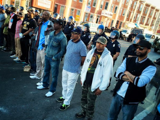 During the 2015 Baltimore protests, citizens formed a line in front of police officers to form a peaceful barrier between law enforcement and protestors.