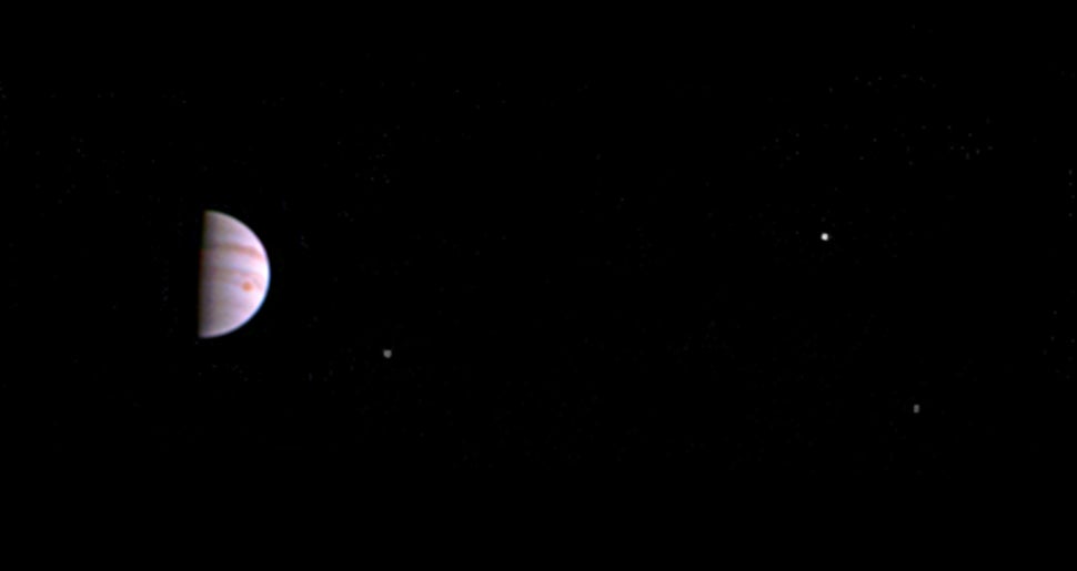 Jupiter and its Great Red Spot can be seen in this first image released by NASA. From left to right, the moons Io, Europa and