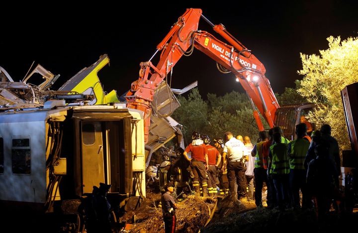 Rescuers work at the site where two passenger trains collided in the middle of an olive grove in the southern village of Corato, near Bari, Italy.