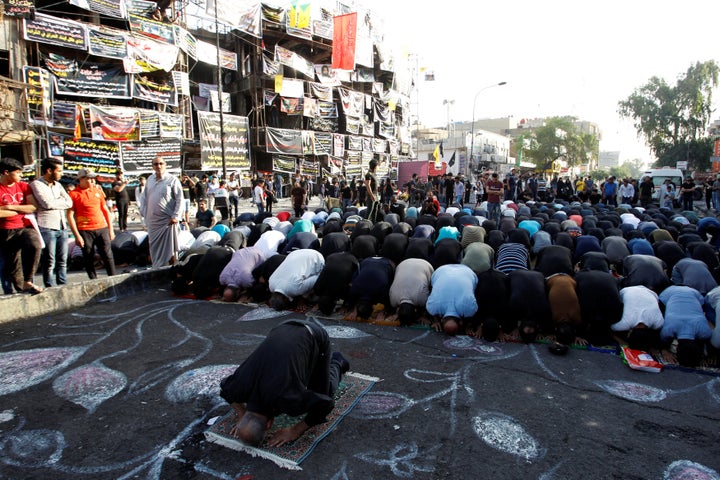 Sunni and Shi'ite Muslims attend prayers in Baghdad on July 6 during Eid al-Fitr as they mark the end of the Muslim holy 