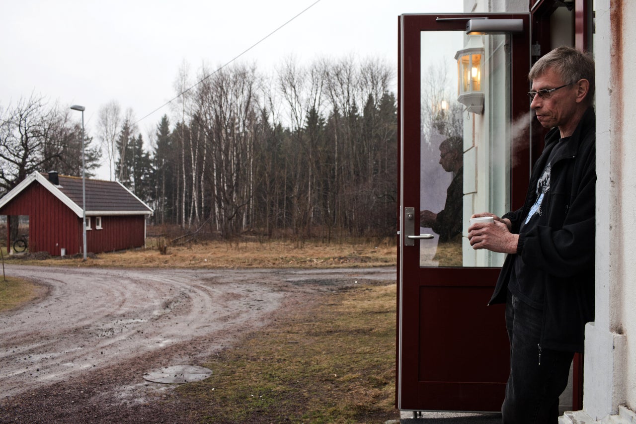 Bjorn, 54, who was sentenced to five and a half years for attempted murder, stands in front of the wooden cottage where he lives in Bastoy Prison on April 12, 2011.