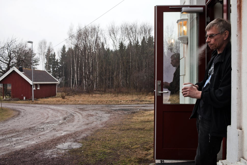 Bjorn, 54, who was sentenced to five and a half years for attempted murder, stands in front of the wooden cottage where