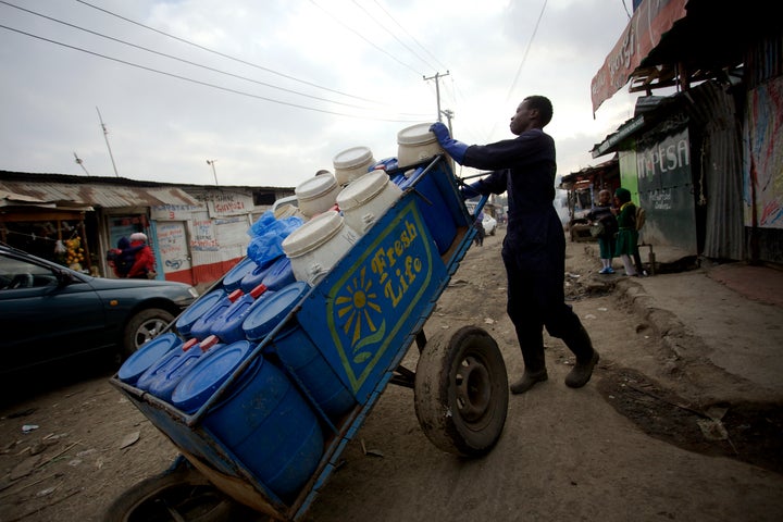 A Sanergy employee transporting the collected waste to the facility for reuse.