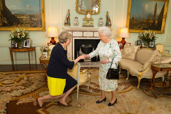 Queen Elizabeth II welcomes Theresa May at the start of an audience in Buckingham Palace, London.