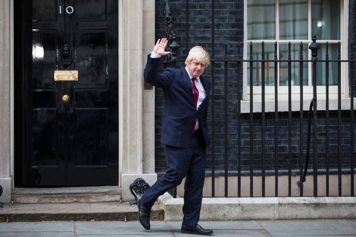 <strong>Boris Johnson waves as he leaves Downing Street after being appointed foreign secretary </strong>