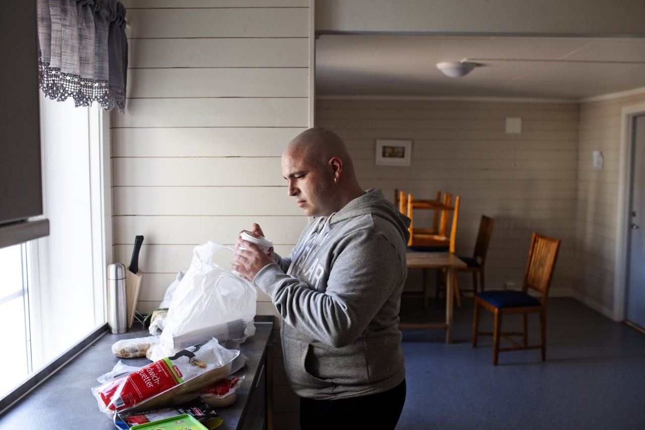 Edven, 38 and sentenced to more than three years for a crime related to narcotics, stands in the kitchen of his wooden cottage in Bastoy Prison on April 11, 2011.