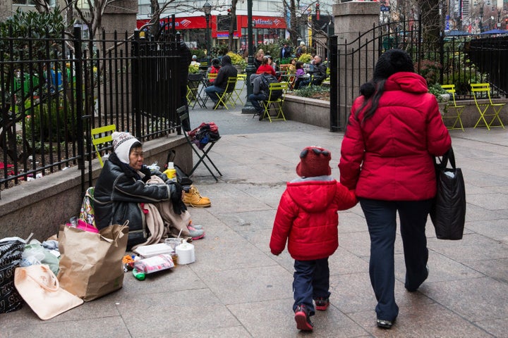 NEW YORK, NY - DECEMBER 21: A woman begs for change near Herald Square on December 21, 2015 in New York City. In the past five years New York's homeless population has ballooned from approximately 38,000 in October of 2010 to over 59,500 in October of 2015, according to Coalition for the Homeless. (Photo by Andrew Burton/Getty Images)