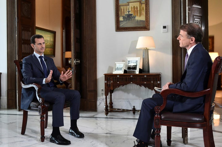 Syria's Bashar Assad, left, denied any wrongdoing in the brutal civil war during a Damascus interview with NBC's Bill Neely on Thursday.