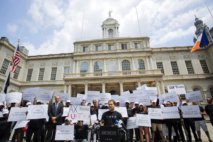 Uber drivers rally at the New York City Hall.