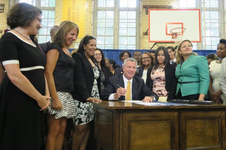Mayor Bill de Blasio signing a package of legislation increasing access to feminine hygiene products for New York City’s shelter residents, students and inmates, at the High School for Violin and Dance in the Bronx, on July 13, 2016.