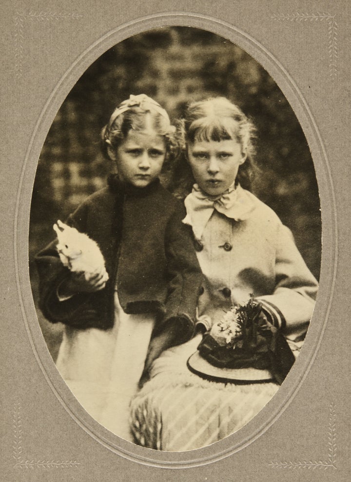 Beatrix Potter with a rabbit and her cousin Alice Crompton Potter.