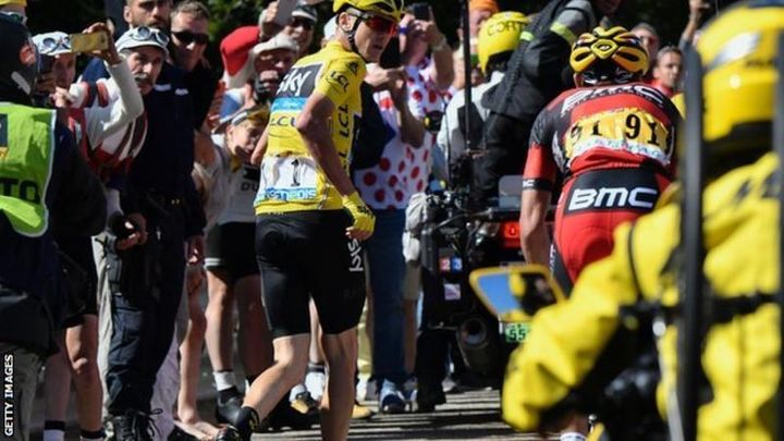 Tour de France leader Chris Froome runs up the last 1 km climb of stage 12 without his bike