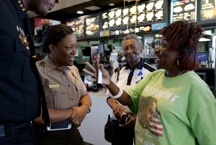 Dorothy Smith, right, talks with Miami-Dade county police officer Delma Noel-Pratt, left, during a Coffee with a Cop event at a local McDonald's on April 27, 2016, in Miami Gardens, Florida.