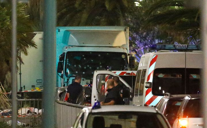 French police forces and forensic officers stand next to a truck that ran into a crowd celebrating Bastille Day on Thursday in Nice, France.