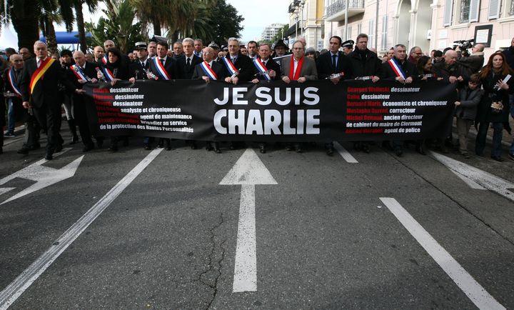 People holding a banner reading "I am Charlie", take part to silent walk for victims of the shooting at the satirical newspaper Charlie Hebdo, Saturday, Jan. 10, 2015, in Nice.