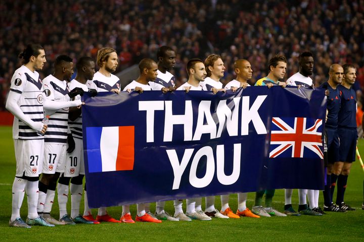 The Bordeaux team hold a banner thanking the British people for their recent support in the wake of the Paris terror attacks.