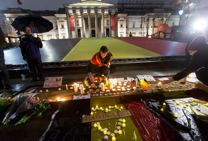 People leaving leave flowers and candles during a vigil in Trafalgar Square in London, to pay tribute to the victims of the terror attacks in Brussels, Belgium.