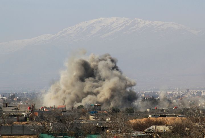 Smoke rises over Darayya after government forces drop barrel bombs on the community, according to activists.