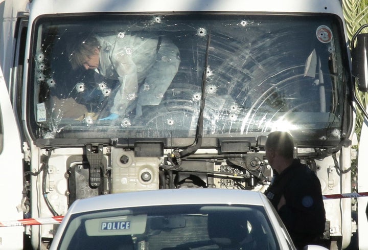 Police investigate a truck riddled with bullets at the scene of a terror attack in Nice, France.