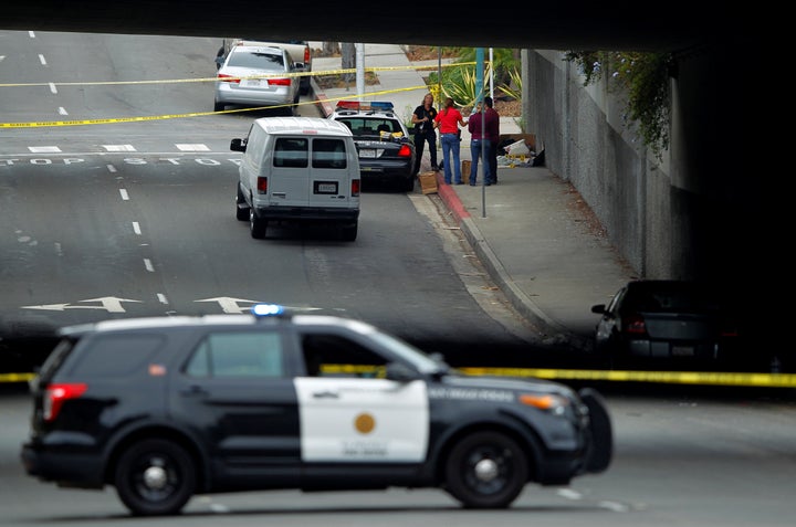 Police investigate the scene under a highway overpass where another apparent attack by a serial killer targeting homeless men took place overnight in San Diego, California United States, July 15, 2016. REUTERS/Mike Blake