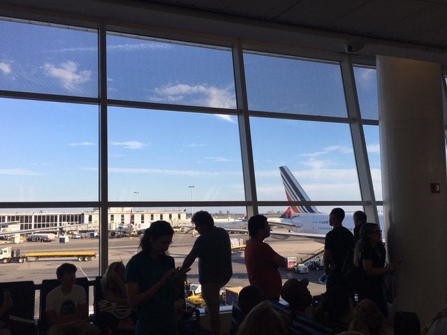Travelers await news about the situation in Istanbul in JFK's Terminal 1.<i></i>