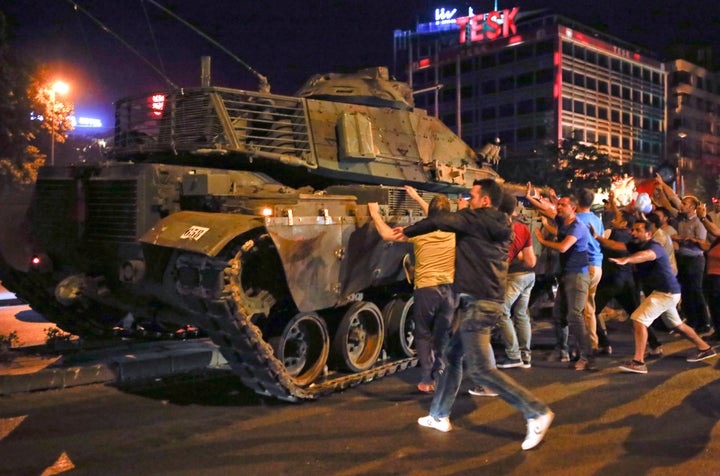 People in Turkey swarm a tank in the streets amid an attempted military coup.